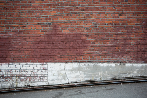 A rough dirty wall makes for an interesting background or backdrop in an urban environment.