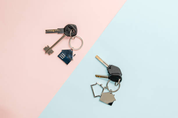 istock Keys with keychain with shape of house on two colored background 1712859545