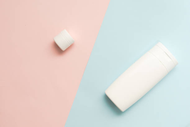istock Flat lay of cosmetic bottles and tubes on two colored background 1712859559