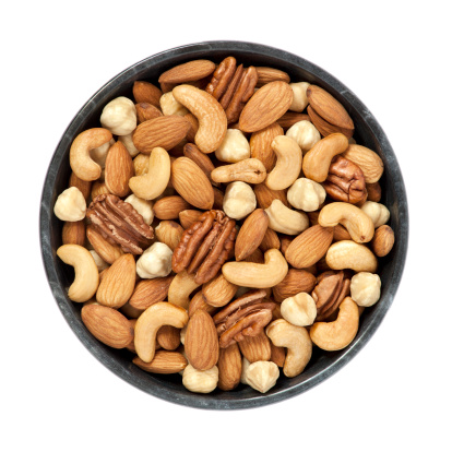 Mixed nuts in a bowl on white background