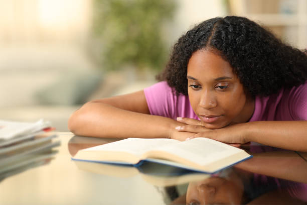 istock Serious black woman reading a paper book 1712862306