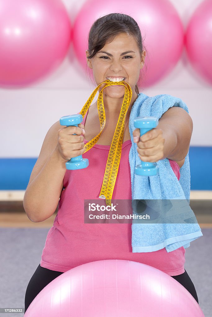 beautiful overweight woman doing pilates and biting measure tape "beautiful overweight woman doing pilates and biting a measure tape for dieting concepts, selective focus" Adult Stock Photo