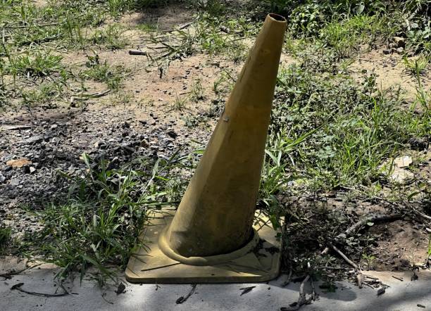 istock a cone sitting in the grass next to a sidewalk.. 1712864005