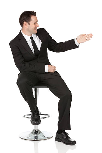 istock Happy young businessman sitting on a chair and gesturing 171286426