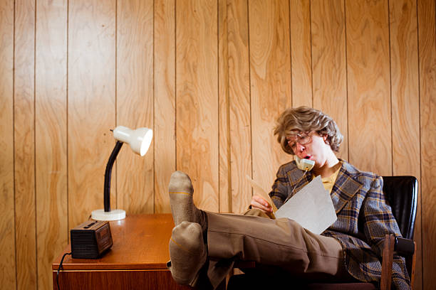 Lazy Office Worker In 1970s Work Space Stock Photo - Download
