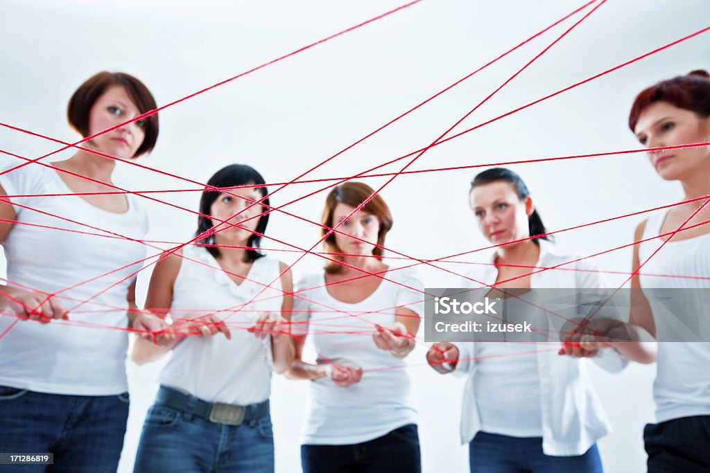 connected to the network Network concept. Group of women holding red rope. Connection Stock Photo