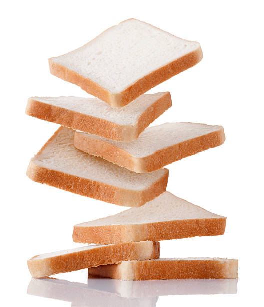 white bread falling slices of white bread. photographed on pure white.Related image: slice of bread stock pictures, royalty-free photos & images