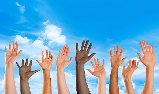 istock Mixed nationality hands waving toward camera with blue sky 171287237