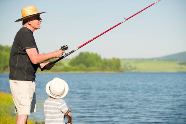 istock Senior man fishing with grandson 171287590