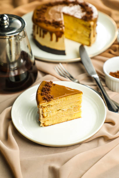 istock Salted Caramel Blondie cake slice include chocolate cream, sugar with fork, cup of coffee and pot served plate isolated on napkin side view of cafe food 1712876628