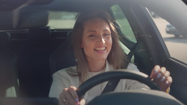 Contented lady expressing satisfaction while driving car