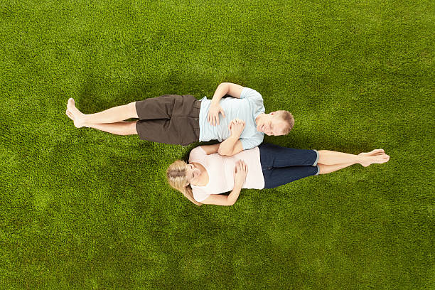 istock Elevated view of a couple lying on grass 171287713