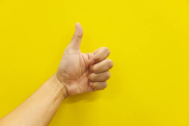 istock Thumbs up on yellow background 1712878228