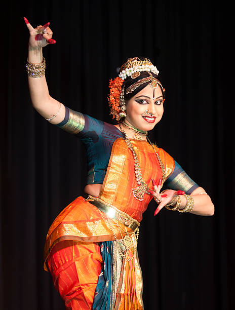 Beautiful Indian Kuchipudi Dancer Performing On Stage Beautiful Indian Kuchipudi Dancer Performing On Stage Wearing Traditional Ornate Costume andJewelry. This is a classical dance from Southern India. bharatanatyam dancing stock pictures, royalty-free photos & images