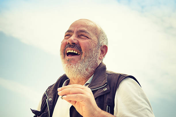 istock senior fisherman smoking cigar and laughing 171288720