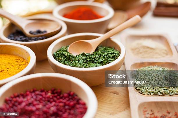 Diferentes Especias En Un Tazón De Madera Foto de stock y más banco de imágenes de Especia - Especia, Hierba - Planta culinaria, Cuenco