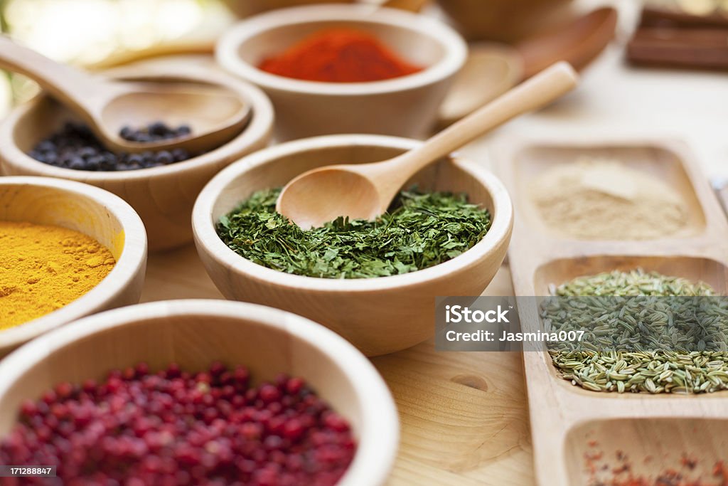 Various spices in wooden bowl Spice Stock Photo