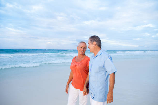 istock Happy senior couple walking on the beach 171288936