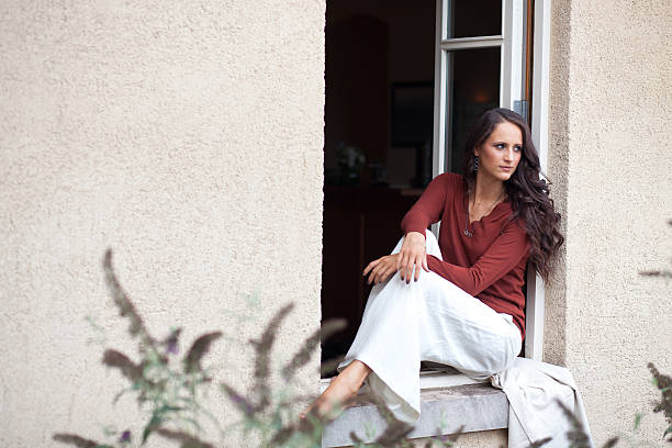 Young girl traveller sitting on a door threshold