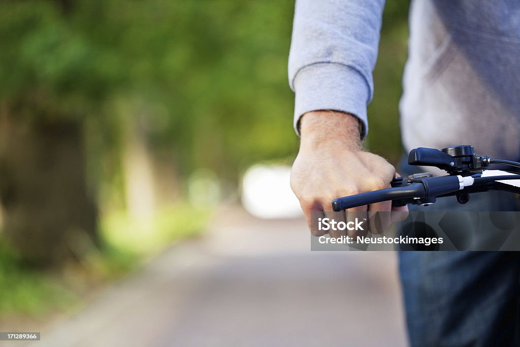 Cyclist With Hand On Brakes Cropped view of a cyclist with hand on brakes. Horizontal shot. Bicycle Stock Photo