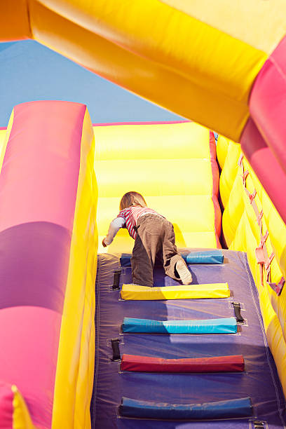 istock Child climbing on inflatable bouncy castle 171289478