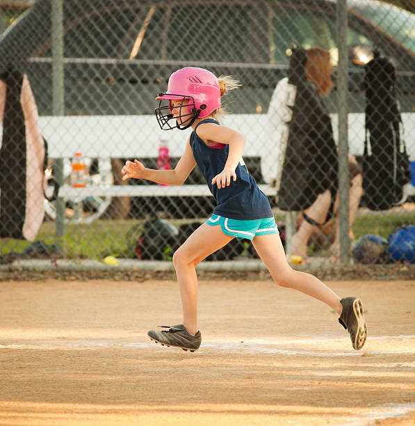 istock Young Girl Running Bases in Softball Game 171289718