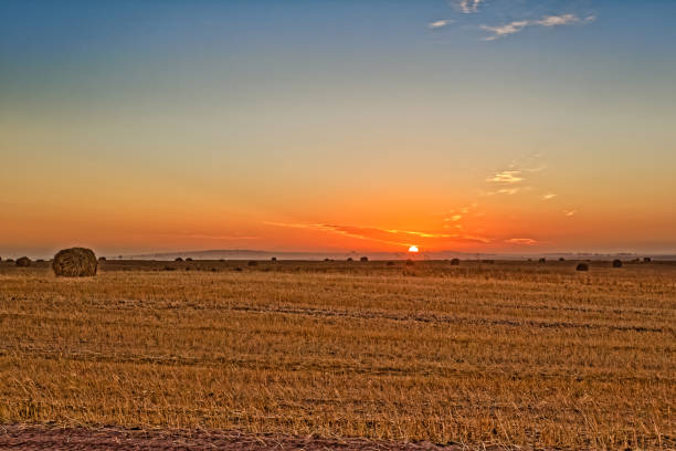 istock Sunrise over hay bales on field 1712901574