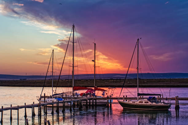 istock Three sailing boats and red sunset 1712902133