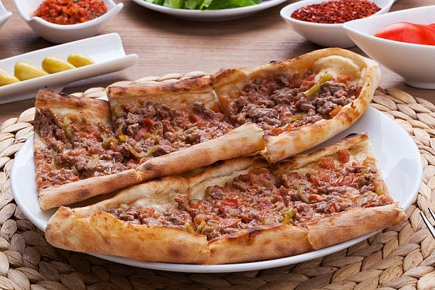 Turkish Pizza - Pide Meaty Pita, thin piece of dough topped with cubed meat. cooked in stone furnace. pita bread stock pictures, royalty-free photos & images