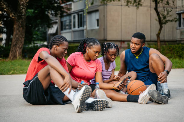 istock Young Black Family Using Phone After A Basketball Game 1712911135
