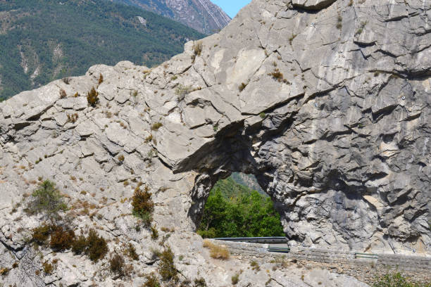 istock a hole in the rock through which a road leads 1712911743