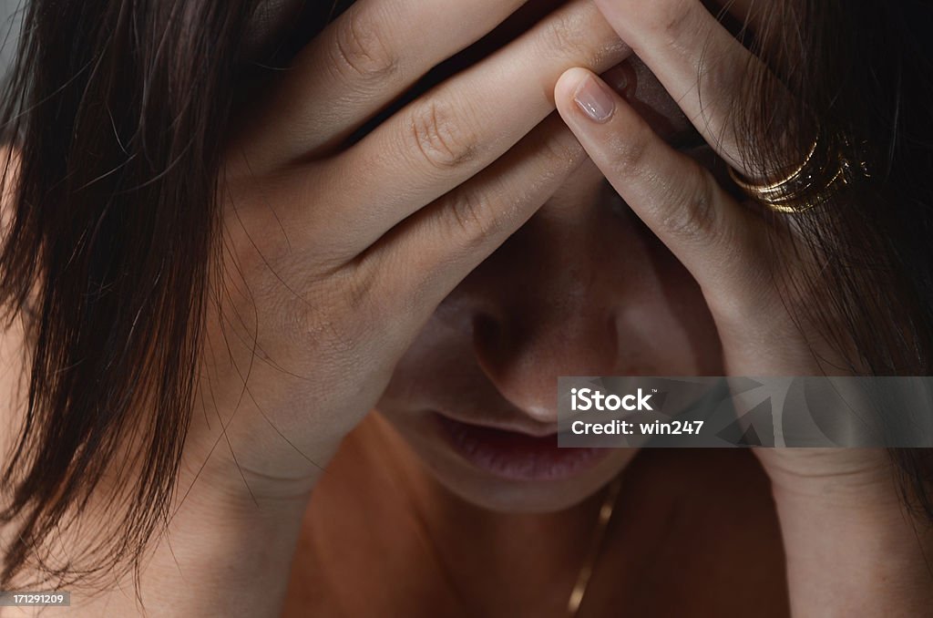 Worried  Depressed Or Praying Caucasian Woman With Head In Hands Worried  Depressed Or Praying Caucasian Woman With Head In Hands. This horizontal stock photo was taken in the studio against a gray background. Head In Hands Stock Photo