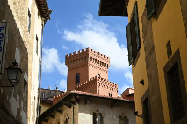 Square brick tower in the city of Pisa in Tuscany