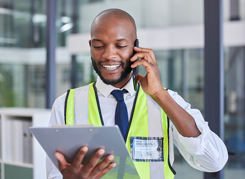 Black man with clipboard, phone call for communication during inspection, safety check and compliance. Logistics or construction with smartphone, tech and checklist for business quality assurance.