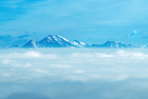 High Julian Alps mountain peaks above the clouds in Slovenia