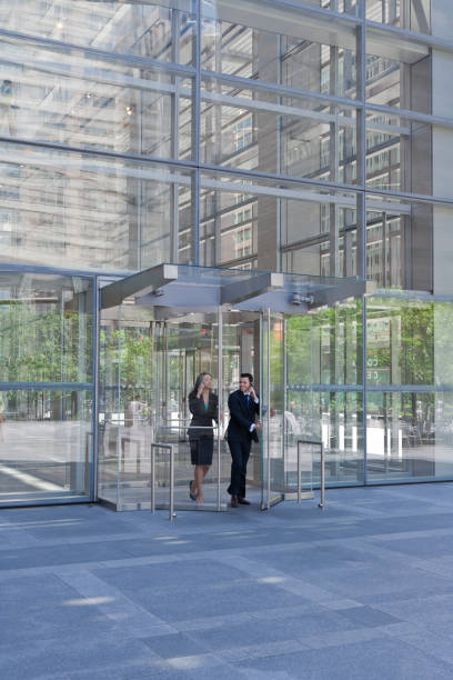 istock Business people exiting through glass doors 171291888