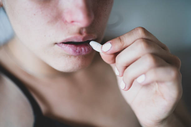 istock Sick woman taking an aspirin. 1712920598