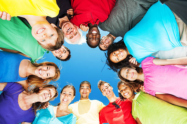 istock Group of embraced people standing in circle against blue sky. 171292064