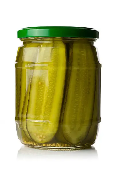 A jar of deli styled pickled gherkins (Cucumber) isolated on a white background.