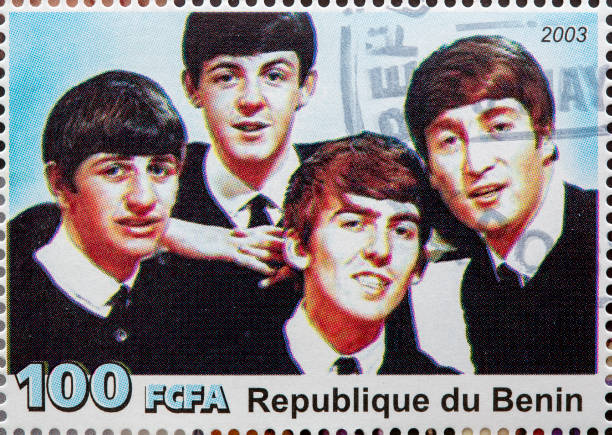 The Beatles "Newcastle, United Kingdom - September 18, 2012: The Beatles featured on a Postage Stamp from the Republique du Benin" beatles stock pictures, royalty-free photos & images