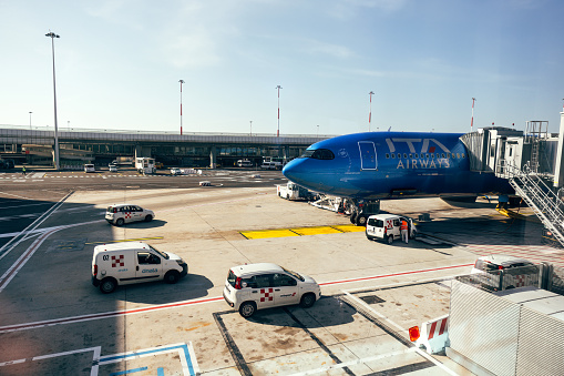 Close Up View Of KLM Royal Dutch Airlines Passenger Airplane Tail At Loading,Unloading Gate Of Schiphol International Airport Amsterdam The Netherlands Europe.Including Architecture And Buildings,Land Vehicle,Passengers Loads On The Ground