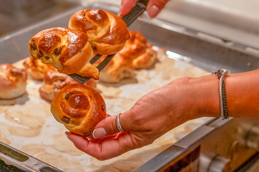 freshly baked buns from the oven in a hand