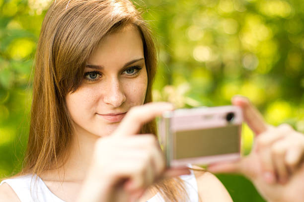 istock Girl taking a picture on point and shoot camera 171292962