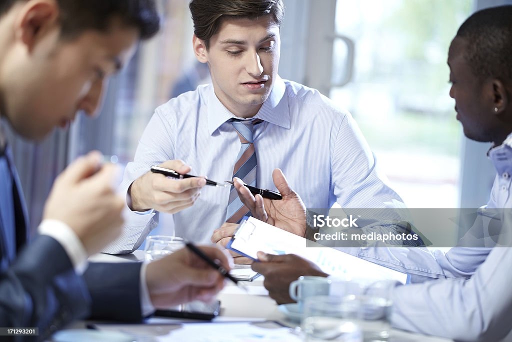Discussion at office Three man talking at office while working 20-24 Years Stock Photo