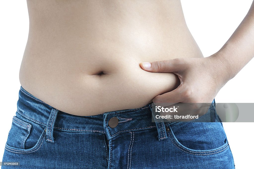 Азиатская женщина, щипание жира на животе ее талии - Стоковые фото Живот роялти-фри