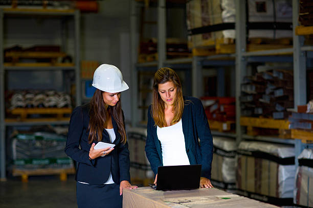 istock Cute inspectors checking supplies in warehouse on laptop 171293792