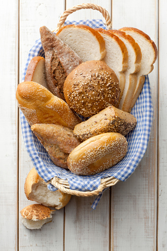 bread in wicker basket isolated on white