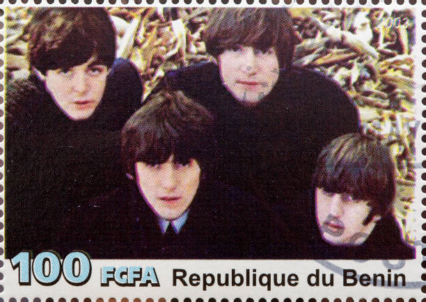 The Beatles "Newcastle, United Kingdom - September 18, 2012: The Beatles featured on a Postage Stamp from the Republique du Benin" beatles stock pictures, royalty-free photos & images