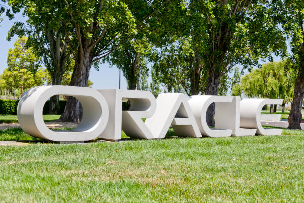 Oracle Headquarters Redwood Shores "Redwood Shores, California, USA - June 15, 2012: A large Oracle sign sits on a lawn outside 500 Oracle Parkway in Redwood Shores, the headquarters of Larry Ellison's Oracle Coporation." oracle building stock pictures, royalty-free photos & images