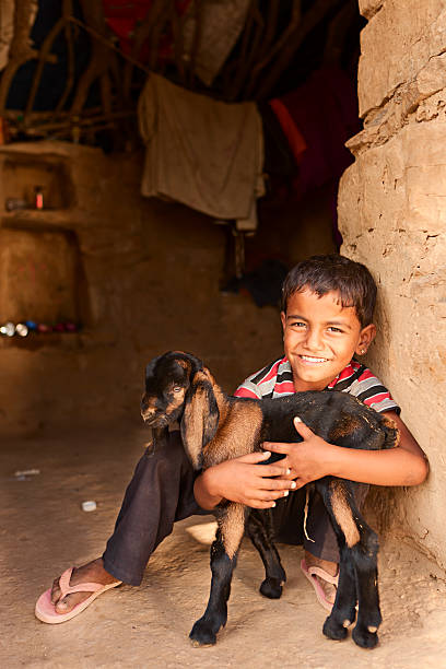 istock Young Indian boy holding a goat 171295251